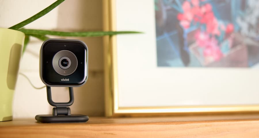 Vivint interior camera sitting on a mantel next to a picture